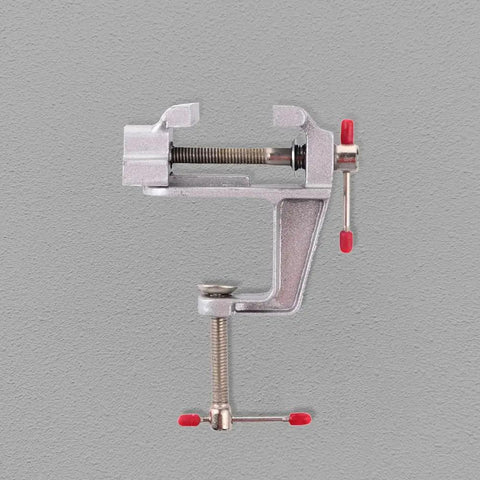 Reliable Mini Bench Vise With Quick Release Table Clamp And Drill Press Mount holds rock solid, showcasing a sturdy metal construction.