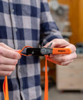 Person holding a Heavy-Duty Adjustable Band Clamp For Woodworking And Framing, 15-Foot Strap, Self-Locking Ratcheting Handle
