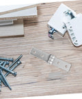 Front view of a stainless steel heavy-duty hinge strap with three mounting holes on wood surface.