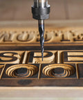 Close-up of a carbide end-mill bit with 1/8 in shank and tapered cone nose carving wooden letters.