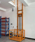 Heavy Hitter Electric Hydraulic Lift Table With A Rock Solid Steel Frame, orange lift platform beside storage shelves.