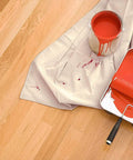 Heavy Duty Cotton Canvas Drop Cloths 4x5 Feet Pack Of 4 Thick Painter Cloths To Protect Furniture And Floors From Paint Messes During DIY Projects And Messy Painting Jobs covering floor with red paint bucket and roller.
