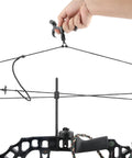 Hand holding Ultimate Game Changing Archery Bow Release For Compound Bows, Durable Aluminum Caliper Thumb Release on string.