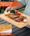 Man holding bamboo cutting board served with grilled chicken, using 5 In 1 Grill Prep Tray And Carry System For Outdoor Barbecues.