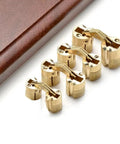 Two Pack Brass Cylindrical Concealed Cabinet Hinges for Easy Install, quiet smooth operation next to a wooden surface