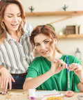 Two women engaged in crafting with the Premium 46 Piece Pin Vise Hand Drill Set With 45 Mini Twist Drill Bits Ranging From 0.3 To 3 Mm.