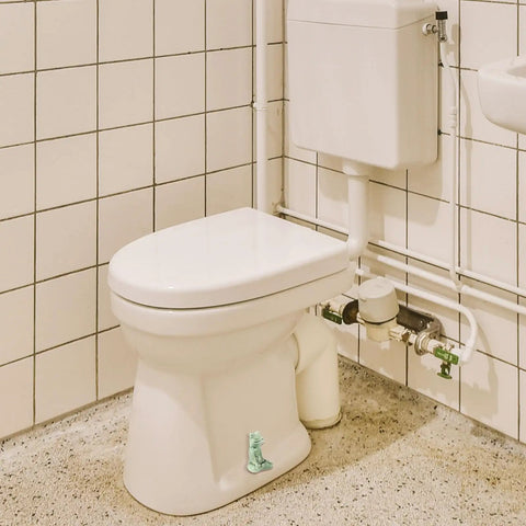 Kick Up Your Bathroom Style With These Pretty Dang Cute Ceramic Frog Toilet Bolt Cover Set Featuring Sturdy Tank Caps And Whimsical Hardware Accessories on a white toilet.