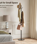 Freestanding Coat Rack With Natural Marble Base And 10 Hooks in a bedroom, featuring bags and hats, black metal stand.