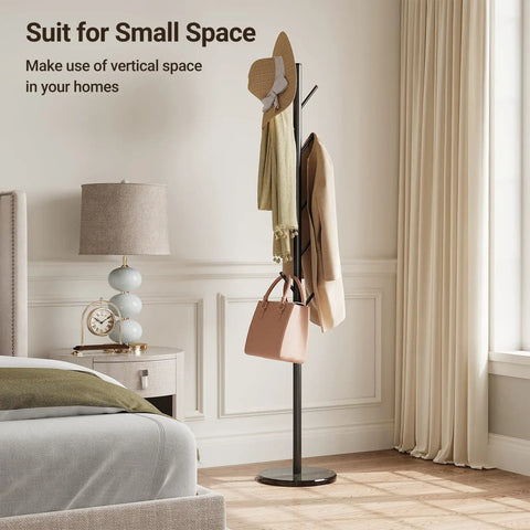 Freestanding Coat Rack With Natural Marble Base And 10 Hooks in a bedroom, featuring bags and hats, black metal stand.
