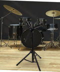 Rock Solid 12 Inch Folding Drum Rack Set With Adjustable Snare Stand Portable Black Drum Holder For Silent Practice in a music room setting.