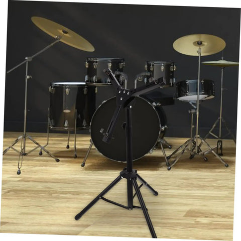 Rock Solid 12 Inch Folding Drum Rack Set With Adjustable Snare Stand Portable Black Drum Holder For Silent Practice in a music room setting.