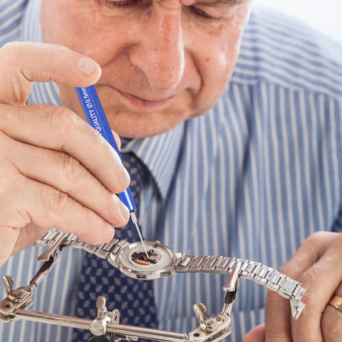 Close-up of a person using Pro Grade Watch Oil Pen Tool for Precision Lubrication on a mechanical watch gear.