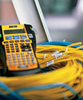 RhinoPRO 5200 Heavy Duty Label Maker With Carry Case for job sites resting on coiled network cables. Fast printing.