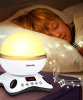 Child sleeping beside the Awesome Kids Night Light Projector With Remote, glowing softly with music notes, in a nursery setting.