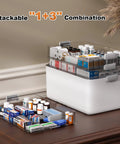 Front view of white 4-tier medicine storage organizer with clear lids and a handle; removable tray.