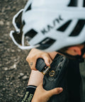 Cyclist using All-In-One Bike Multitool M19 Matte Black With Hex Wrenches for bike shoe repair
