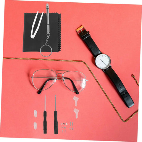 Eyeglass Repair Tools Kit With Screws Nose Pads And Tiny Screwdriver For Quick Glasses Fix On The Go Portable Eyewear Maintenance Kit For Enthusiasts And DIY Fixers displayed with glasses and a watch.