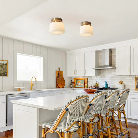 Modern Brushed Gold Semi Flush Drum Ceiling Light Fixture With Milk Glass Shade in a bright kitchen setting