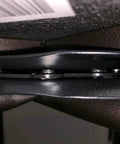 Close-up of 3 Piece Six and a Quarter Inch Bar Stool Swivel Plate Heavy Duty Steel Seat Swivel Base Mount in black, showing bolts and steel plate.