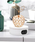 Luxshiny Electric Jewelry Rotating Turntable Display Stand with smooth auto-spin showcasing a decorative crystal apple.