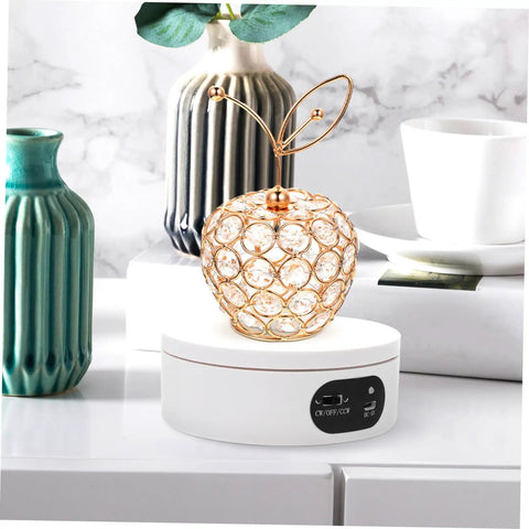 Luxshiny Electric Jewelry Rotating Turntable Display Stand with smooth auto-spin showcasing a decorative crystal apple.