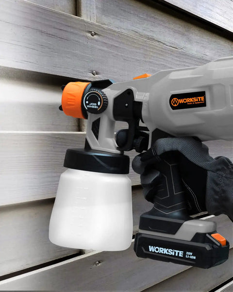 Cordless 20V Paint Sprayer Gun With Dual Batteries, HVLP Sprayer against wooden wall, adjustable valve knob visible