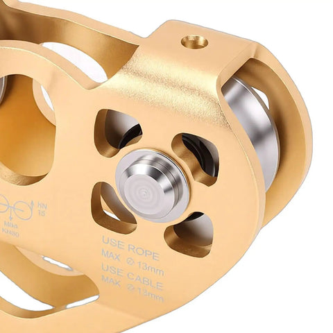Close-up of heavy duty zipline pulley with tandem dual trolley for cable rope 30KN strength showing smooth stainless bearings.