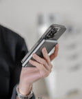 Person holding a Straight Up Top Shelf MagSafe Power Bank with iPhone, featuring slim design and secure magnetic snap.