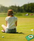 Putting Cup With Flag Indoor Golf Hole Practice Kit on grass next to seated person, ideal for home and outdoor use