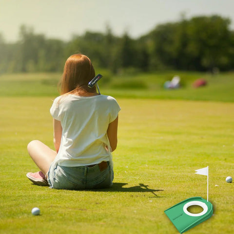 Putting Cup With Flag Indoor Golf Hole Practice Kit on grass next to seated person, ideal for home and outdoor use