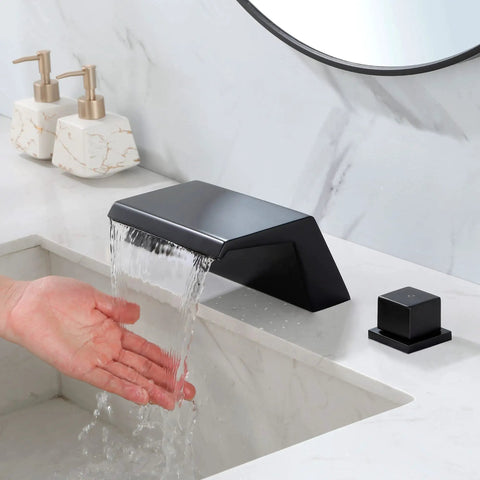 Matte Black Waterfall Tub Filler Deck Mount With Three Hole Roman Tub Faucet And Two Square Handles Valve Included And cUPC Water Supply Lines All Solid Brass Construction - water flowing from spout with hand under cascade