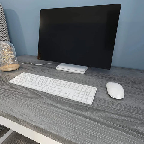Desk with gray wood grain contact paper 24x200 self adhesive peel and stick for cabinets, featuring a computer setup.