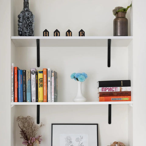 12 Pack Matte Black Heavy Duty Shelf Brackets With Screws Built Like A Tank For Rustic Home And Garage Shelving holding books and decor.