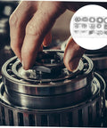 Hand installing 175 Piece Steel C Type External Circlip Snap Ring Assortment Kit For Automotive And Machinery In Clear Storage Case.