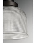 Close-up of Archie Collection One Light Pendant In Venetian Bronze With Clear Prismatic Glass, detailed glass texture visible.