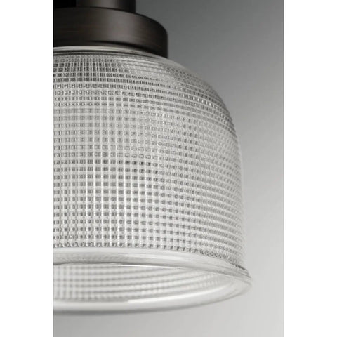 Close-up of Archie Collection One Light Pendant In Venetian Bronze With Clear Prismatic Glass, detailed glass texture visible.