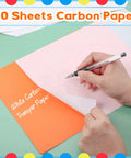 Hand using 30 Pack Graphite Transfer Paper for Tracing and Copying Lines on Canvas and Wood, 8.5 x 11 Inches White Erasable Carbon Paper Set