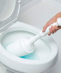 Heavy Duty Toilet Plunger Kit With Smart Air Relief Valve And Spacious Tall Bucket Caddy Effortlessly Knocks Out Stubborn Drain Clogs Fast No Hassle Cleanup For Quick Home Plumbing Fixes In White being used in toilet bowl.