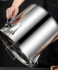 Hand holding a large capacity 304 stainless steel airtight food storage canister, enhancing kitchen organization.