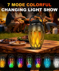 Flame Lamp Speaker With Multicolor Lights For Outdoors Patio Pool Camping Waterproof Torch Lantern 7 Lighting Modes And Music Sync RGB Glow For A Dope Vibe Lit Ambience And Great Gift For Men Him Dad on picnic table at night