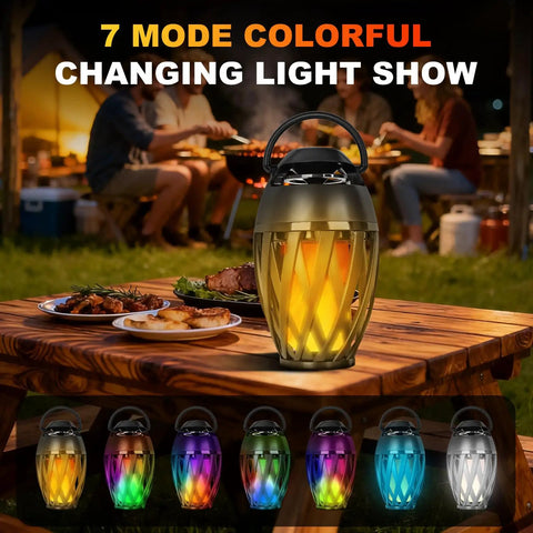 Flame Lamp Speaker With Multicolor Lights For Outdoors Patio Pool Camping Waterproof Torch Lantern 7 Lighting Modes And Music Sync RGB Glow For A Dope Vibe Lit Ambience And Great Gift For Men Him Dad on picnic table at night