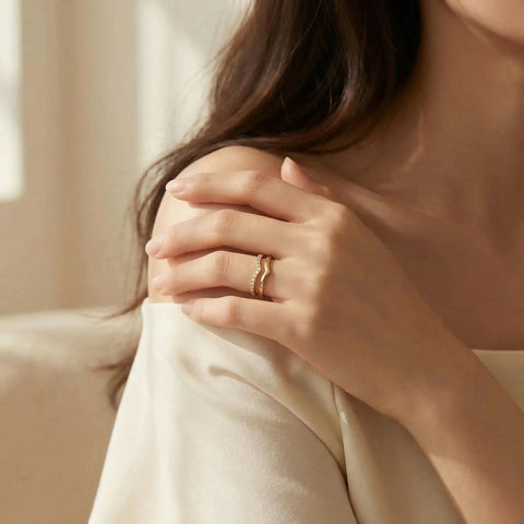Woman wearing stackable pinky ring for women stainless steel solitaire band in gold, non tarnish wedding ring comfortable fit size 3 through 12