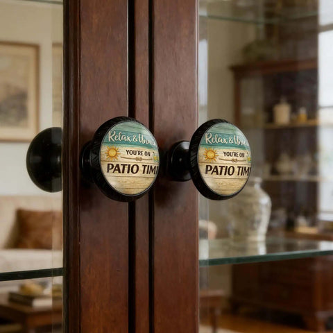 Relax And Unwind Patio Sign Cabinet Knobs 4 Pack Acrylic Round Drawer Pulls For Dresser Cupboard And Doors You're On Patio Time Vibe Hardware That Adds Chill And Easy Pulls installed on a wooden glass cabinet in a room.