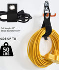 Heavy Duty Garage Hooks 24 Piece Set With 6 Sizes Wall Mount Iron Anti Slip Storage Hanger Organizer For Ladders Power Tools Bikes Ropes And More Includes Holder Strap For Maximum Garage Organization For Gear Heads, holding a yellow extension cord and black strap