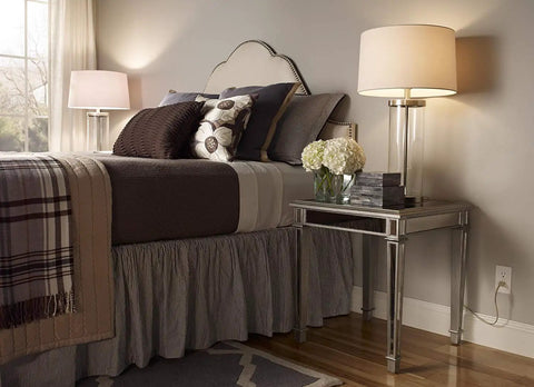 Stylish bedroom with a modern lamp and table, showcasing safe electrical outlet. Includes 20 Amp AFCI Outlet With Self Test.