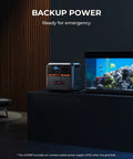 Portable Solar Generator Kit With 350W Panel, 1440Wh Power Station, positioned indoors beside an aquarium for emergency backup.