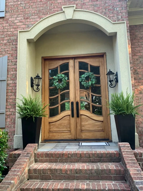 Wooden double doors with glass inserts, decorated with wreaths, suitable for Heavy Duty Double Door Lever Lock Set, Model X201110BSET.