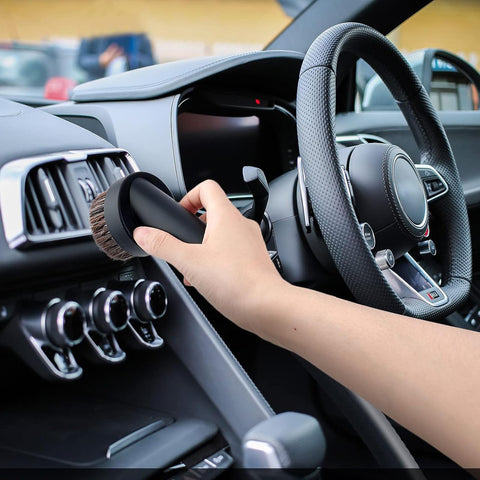 Person using 36mm Long Horse Hair Vacuum Brush With Universal Connector For 32mm And 1-1/4 Hose on car dashboard showcasing soft bristles