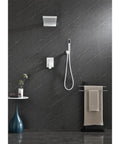 Shower System with Waterfall Rainfall and Handheld mounted on a dark wall, featuring brass and white components.