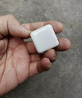 Hand holding 1.25 Inch Glossy Ceramic Square Cabinet Knob White; part of a 6 Pcs set, easy install drawer pull handle for kitchen or dresser.